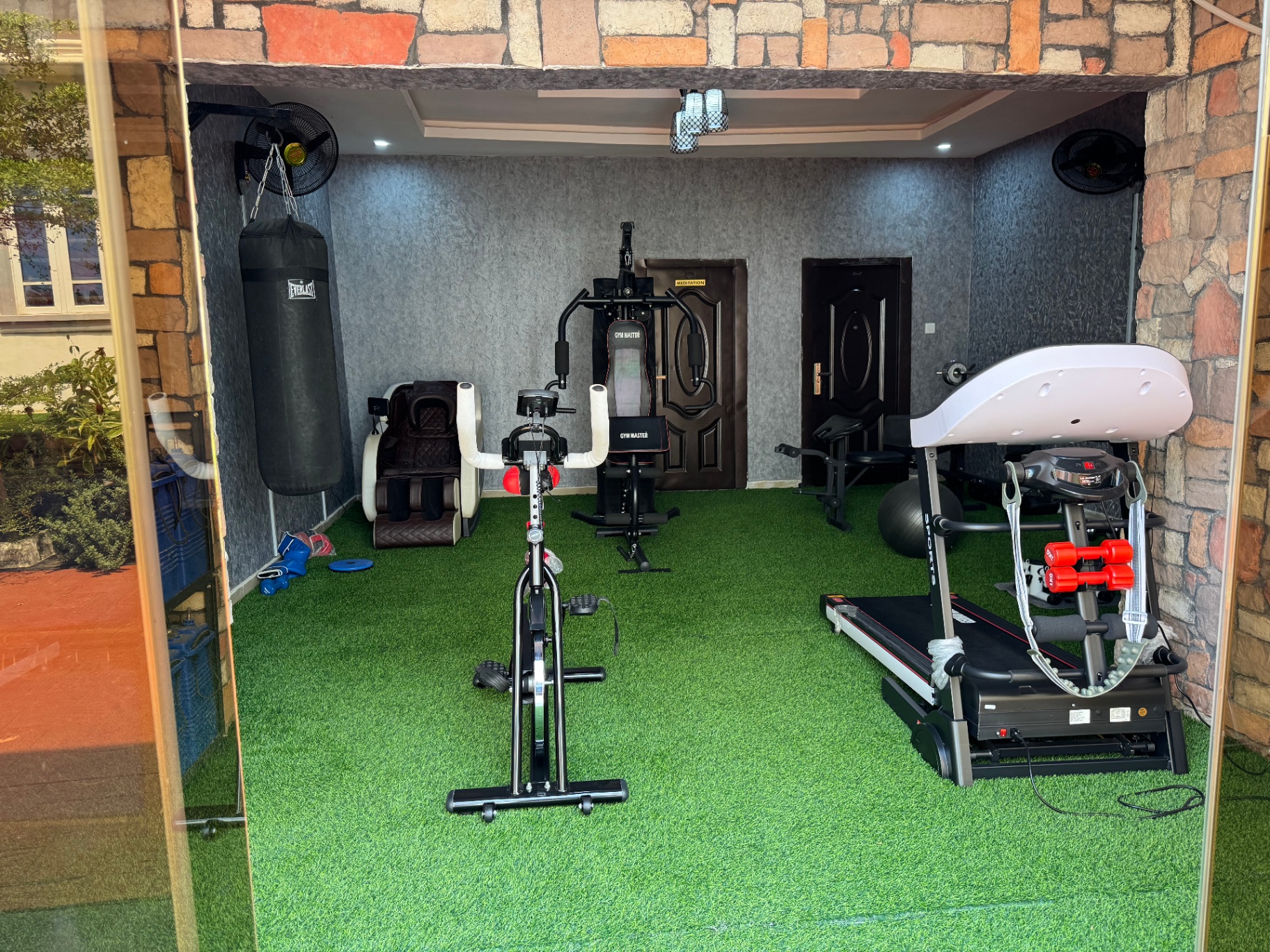 Fitness center with exercise equipment and artificial grass flooring